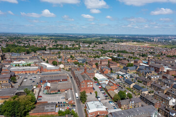 Aerial photo of the village of Morley in Leeds, West Yorkshire in the UK, showing a birds eye drone view of the street and housing estates on a sunny day in the summer time