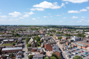 Aerial photo of the village of Morley in Leeds, West Yorkshire in the UK, showing a birds eye drone view of the street and housing estates on a sunny day in the summer time