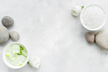 Layout of white cosmetics products and roses flowers, top view