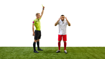 Referee raising yellow card to man, player showing confused expression, illustrating caution warning in soccer game, isolated on white background. Concept of sport, fair play, competition, control