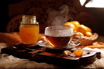 Tea with tangerine confiture on a wooden background