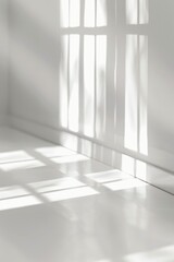 Fototapeta premium White room with a window that is letting in sunlight. The room is empty and the sunlight is casting shadows on the floor