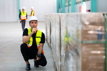 Portrait Professional mechanical engineering hispanic male in white safety hard hat helmet and look at camera at  inventory distribution, storehouse factory