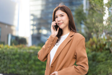 Asian businesswoman on phone urban setting digital remote work professional vibe