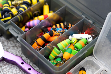 Fishing tackles and fishing baits in box .Classic Colored Fishing Lure , Beautiful Background...