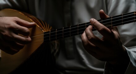 Fototapeta premium Musician playing acoustic guitar in low light