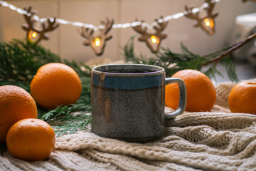 christmas decoration on the table and warm tea in a cup