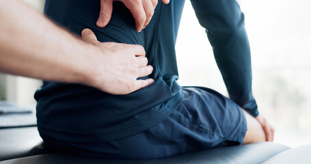 Hands, back pain and injury for massage with physiotherapy at clinic with recovery, process and relief for legs. Person, patient and help for ache, spine and rehabilitation for wellness at hospital