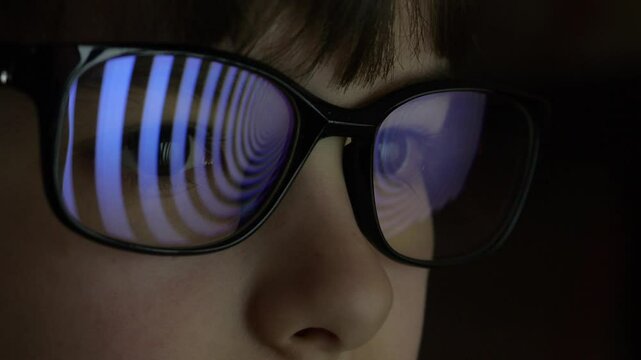 Child Boy With Glasses Watching Hypnotic Screen. Influence of Media on People. Broadcast False Information, Hoax, Propaganda Brainwashing Disinformation. Manipulation Crowd Fakes, False Information.