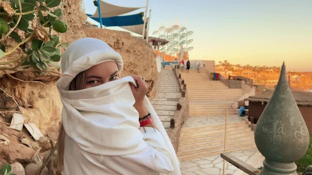 A beautiful girl in traditional clothes rests in a cafe in Egypt