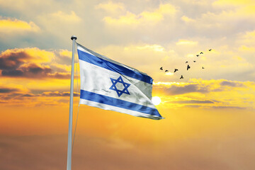 Waving flag of Israel against sunset or sunrise. Israel flag for Republic Day and Independence Day.