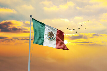 Waving flag of Mexico against sunset or sunrise. Mexico flag for Republic Day and Independence Day.