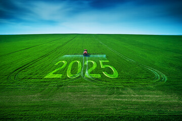 2025 Happy New Year concept and Aerial view of farming tractor plowing and spraying on field.