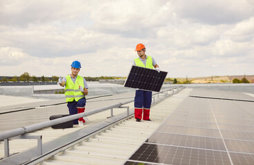 Workers installing and maintaining solar panels on the roof. The photovoltaic system provides renewable energy, ensuring proper setup and service to capture solar power efficiently.