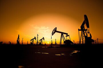 oil pump jack in sunset