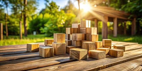 Wooden building blocks scattered on a rustic wooden table in a lush green garden with a golden sunbeam illuminating the scene
