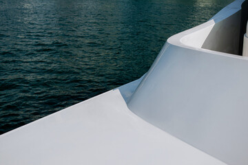 White part of modern yacht against blue water