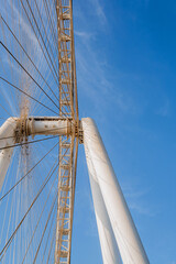 Part of Ferris wheel against the backdrop of a blue sky and the Persian Gulf. Dubai