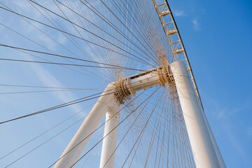Part of Ferris wheel against the backdrop of a blue sky and the Persian Gulf. Dubai