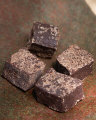 Organic chocolate from the Oaxaca region of Mexico produced in a traditional way on a metate, an ancient stone tool for grinding products.