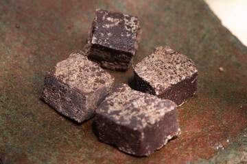 Organic chocolate from the Oaxaca region of Mexico produced in a traditional way on a metate, an ancient stone tool for grinding products.