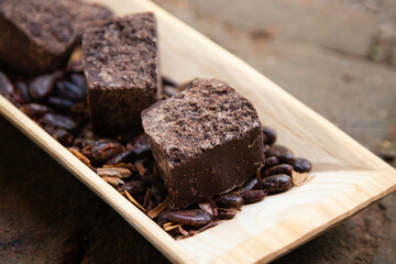 Organic chocolate from the Oaxaca region of Mexico produced in a traditional way on a metate, an ancient stone tool for grinding products.