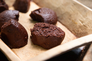 Organic chocolate from the Oaxaca region of Mexico produced in a traditional way on a metate, an ancient stone tool for grinding products.