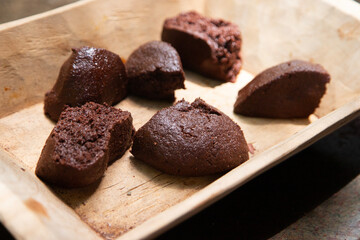 Organic chocolate from the Oaxaca region of Mexico produced in a traditional way on a metate, an ancient stone tool for grinding products.