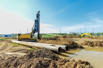 Construction Site with Excavator and Pipes in Action