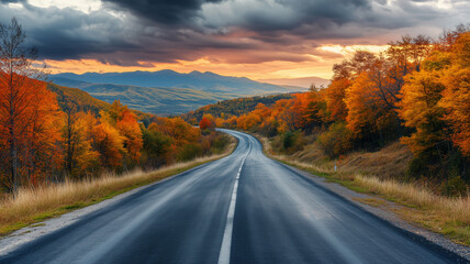 Naklejka premium Autumn Road Through Vibrant Fall Forest