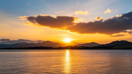 Obraz premium Stunning Golden Sunset Landscape with Clouds and Water Reflection