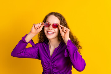Naklejka premium Photo portrait of attractive young woman sunglass fashionista dressed stylish violet clothes isolated on yellow color background
