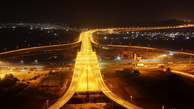 Drone shot view shining roads and overpasses at night