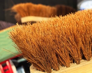 Wooden broom head with brown bristles
