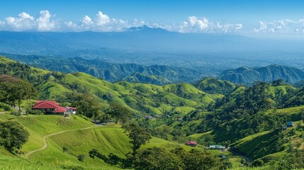 Fototapeta premium A scenic landscape featuring rolling green hills and distant mountains under a clear blue sky.