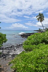 The black sand lava and magma beaches with the turquoise pacific ocean in the back on the big island of Hawaii