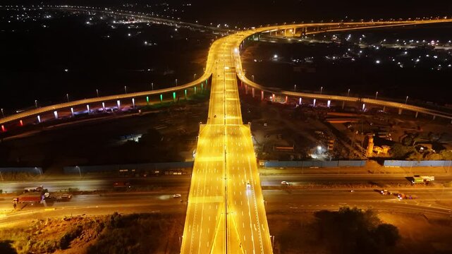Nighttime shot of glowing roads curves overpasses