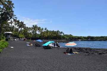 The black sand lava and magma beaches with the turquoise pacific ocean in the back on the big...