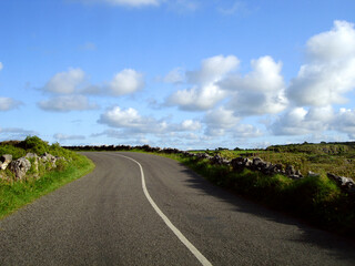 Curve ahead in a country side road in sunny day