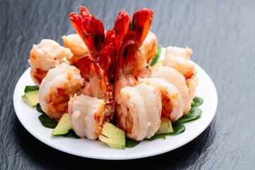 Salad with tiger shrimps , avocado and mango . Top view
