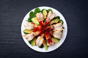 Salad with tiger shrimps , avocado and mango . Top view