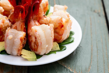 Salad with tiger shrimps , avocado and mango . Top view