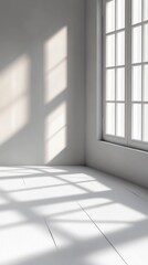 A minimalist room with large windows casts geometric shadows on the white wooden floor, creating an airy and spacious ambiance with a calming and peaceful atmosphere.
