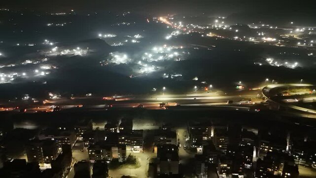 Aerial Cityscape at Night with Illuminated Streets