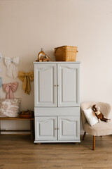 Wooden dresser with handle and wooden bench, stuffed animal, monkey, pillow in children room