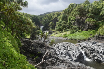 The stunning big wateralls running over the black lava rocks on Maui Island in Hawaii