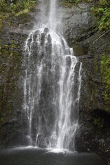 Fototapeta premium The stunning big wateralls running over the black lava rocks on Maui Island in Hawaii