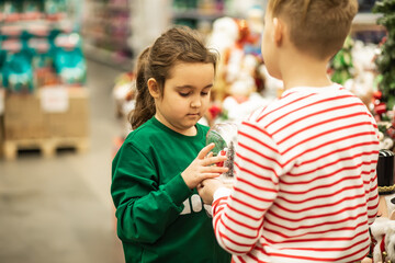 Obraz premium Family sister and brother shopping Christmas presents and decoration in shopping mall
