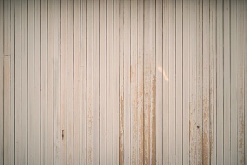 a light-colored wooden surface with vertical planks