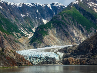 Tidewater terminus of North Sawyer Glacier on a sunny morning late in June at the end of Tracy Arm fjord in southeastern Alaska, for motifs of natural wonders, climate and ecotourism